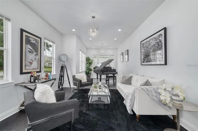 a living room with furniture and painting on the wall