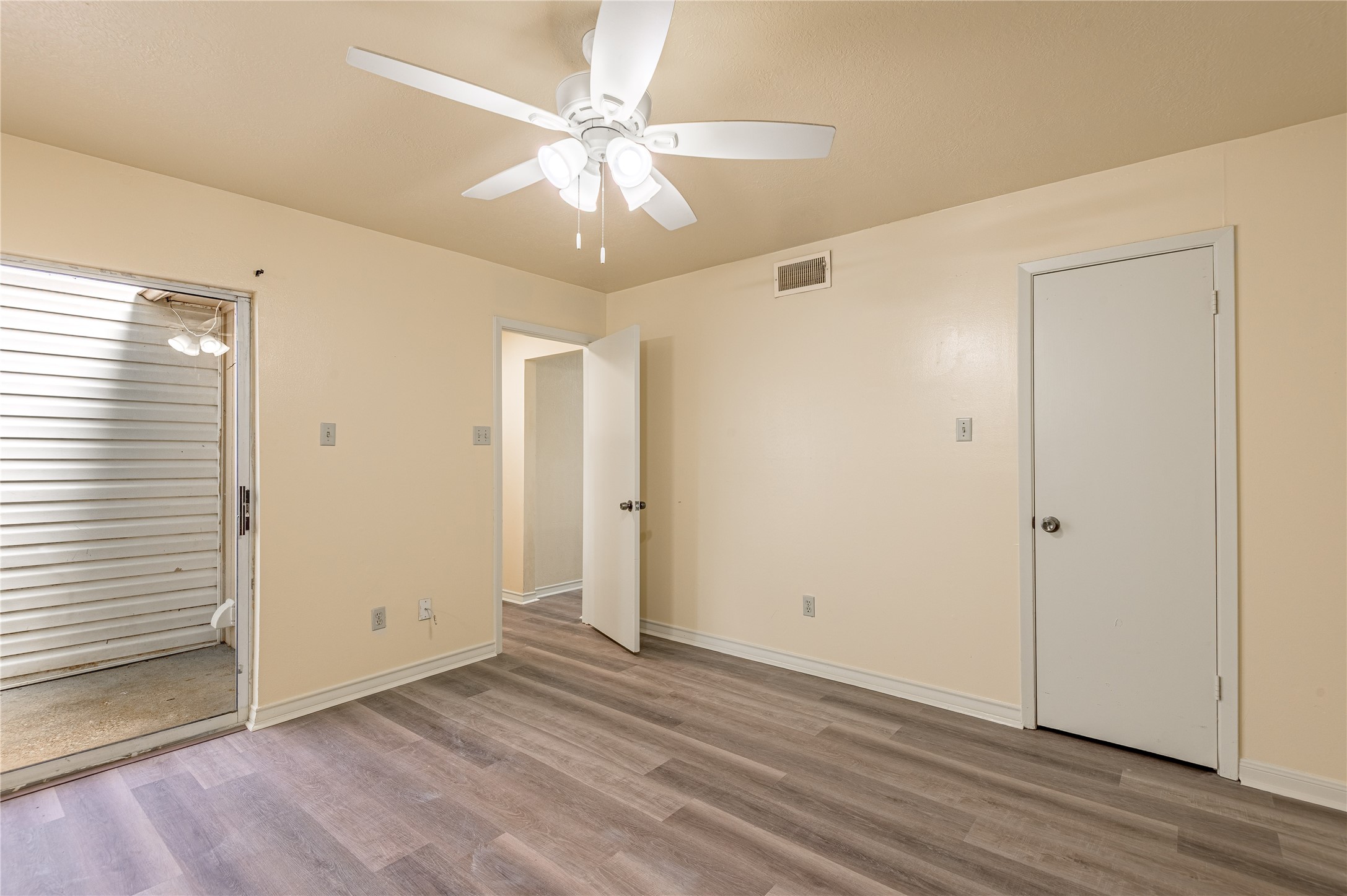 1401 Ave O, Unit F Huntsville, TX 77340 - Photo 11 of 26 a view of an empty room with wooden floor and a window