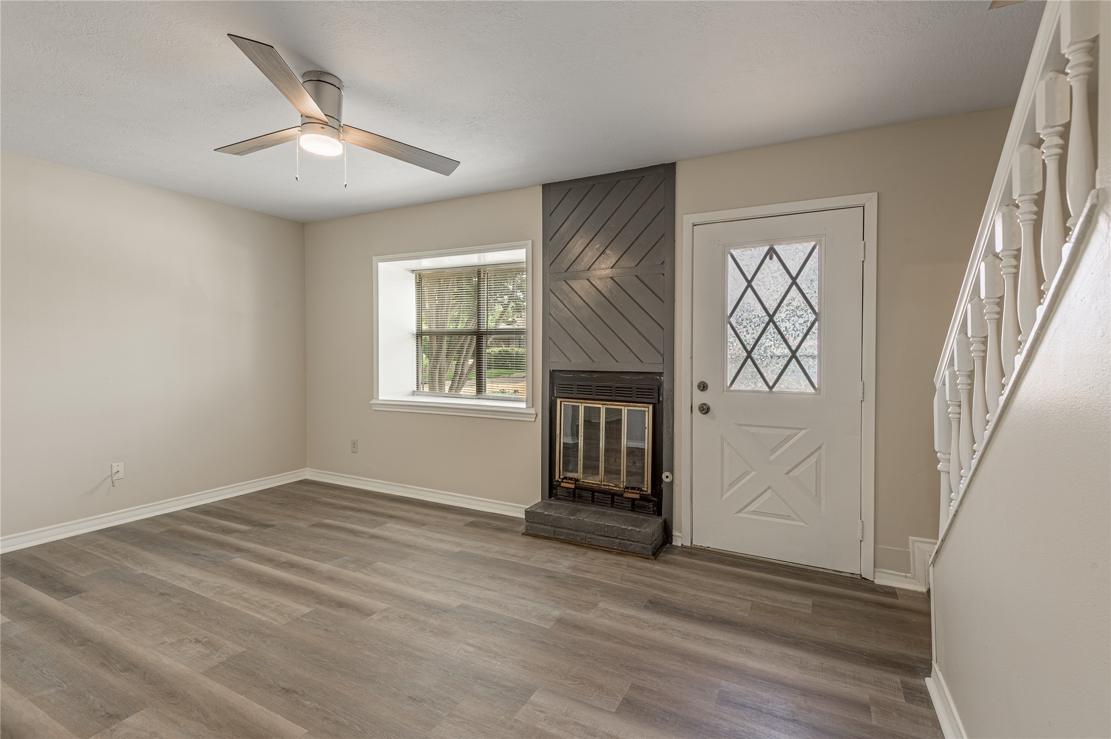 1401 Ave O, Unit F Huntsville, TX 77340 - Photo 2 of 26 a view of an empty room with a window and wooden floor