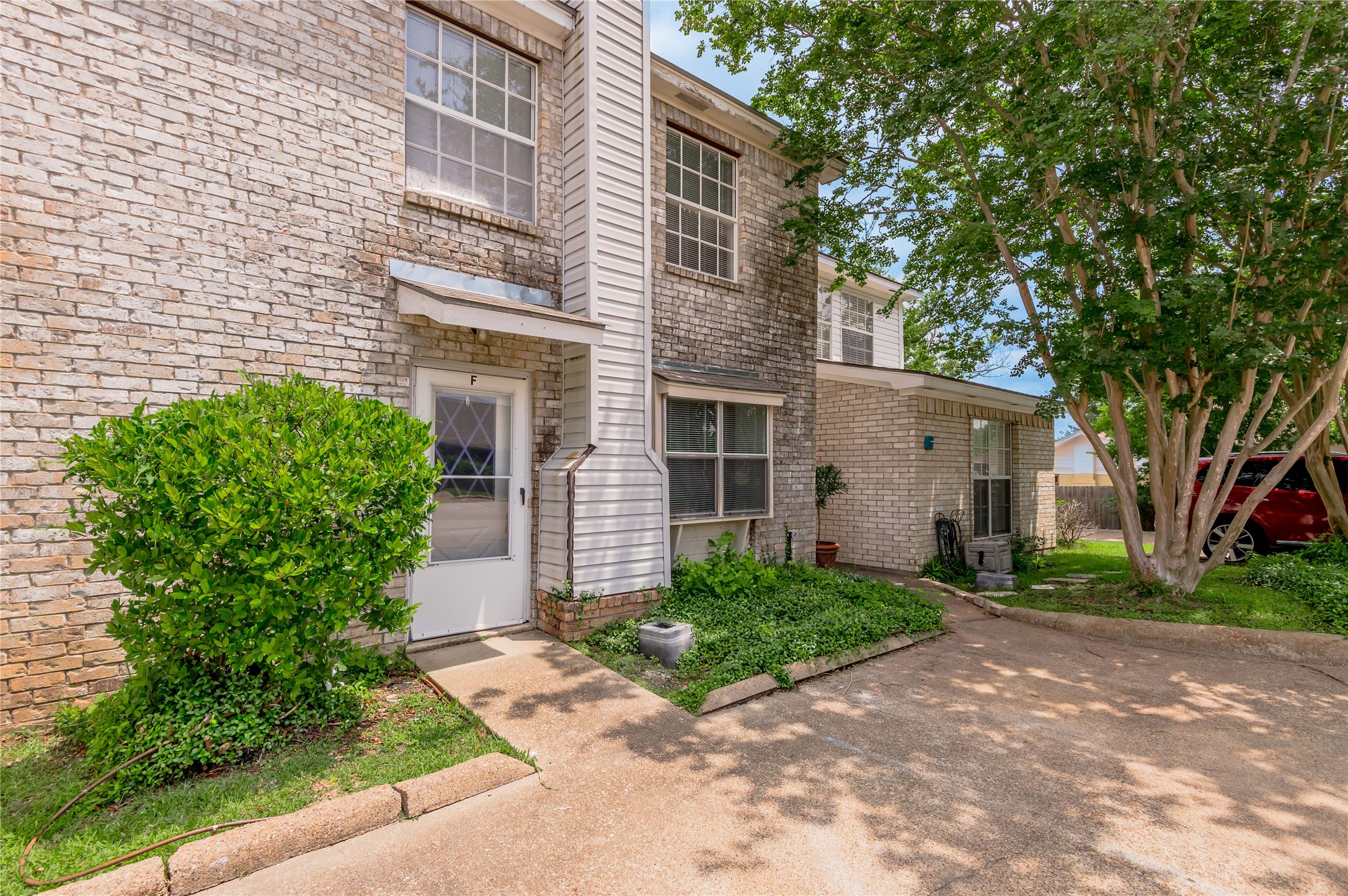 1401 Ave O, Unit F Huntsville, TX 77340 - Photo 22 of 26 a front view of a house with garden