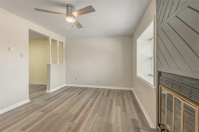 wooden floor in an empty room with a window