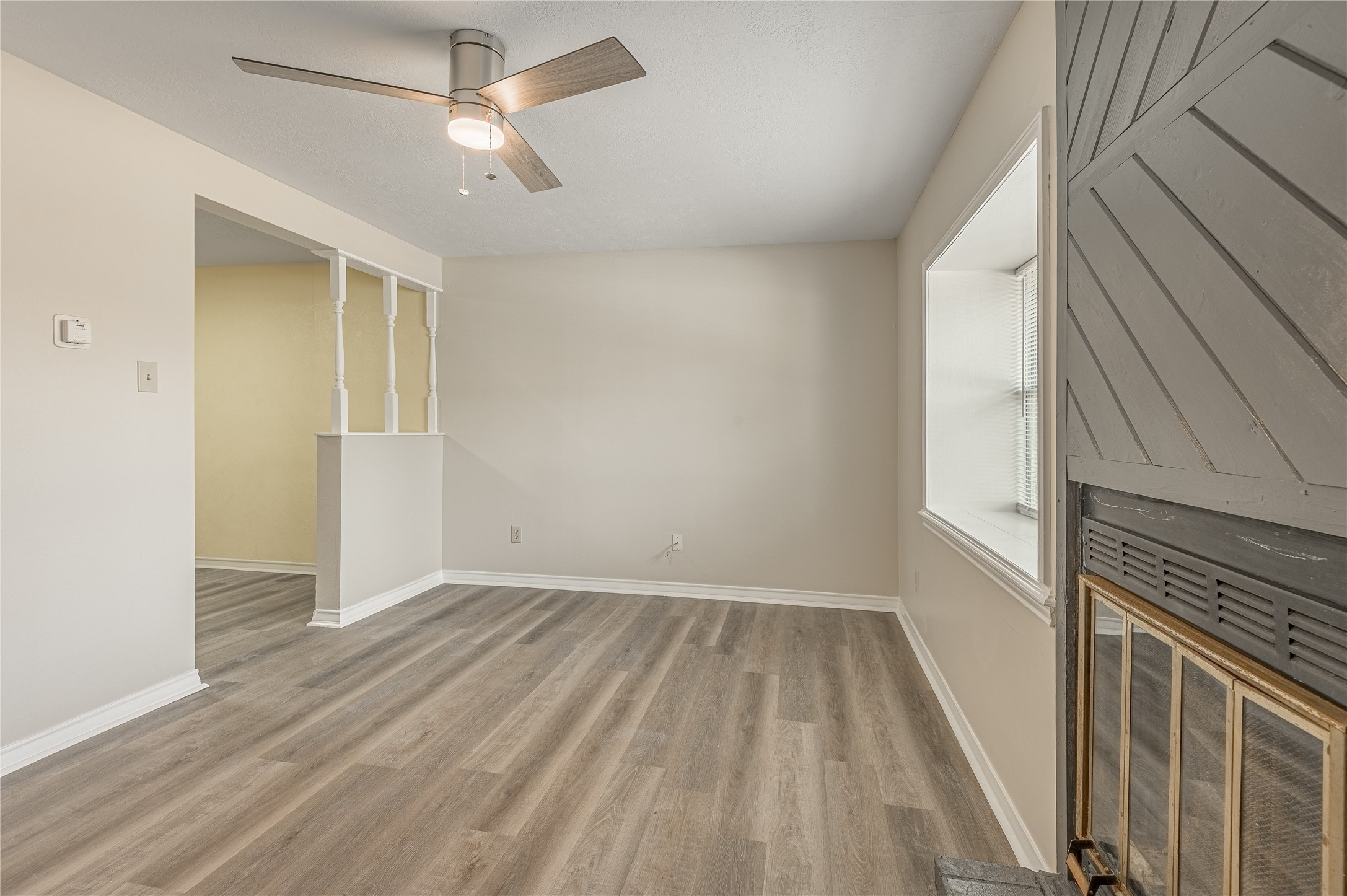 1401 Ave O, Unit F Huntsville, TX 77340 - Photo 3 of 26 wooden floor in an empty room with a window