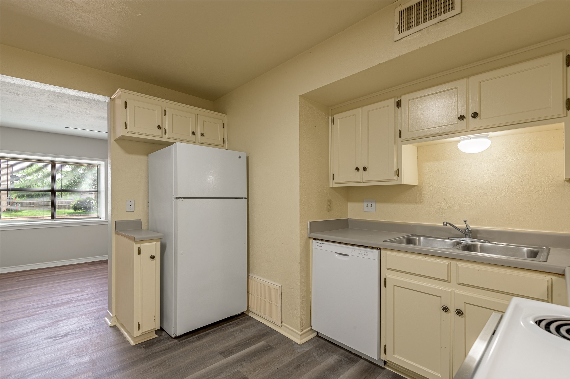 1401 Ave O, Unit F Huntsville, TX 77340 - Photo 6 of 26 a kitchen with a refrigerator sink and cabinets