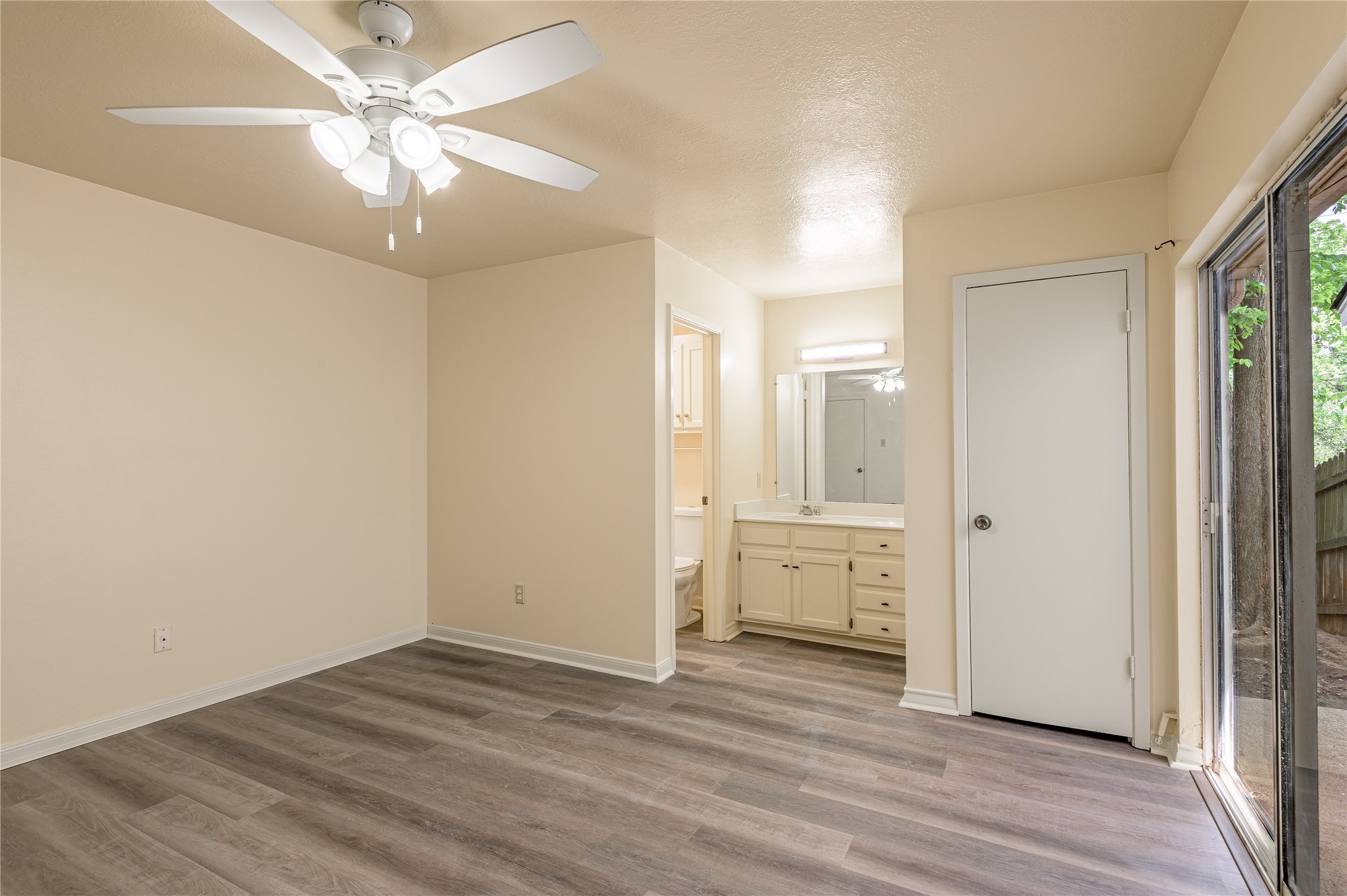 1401 Ave O, Unit F Huntsville, TX 77340 - Photo 9 of 26 wooden floor in an empty room with a window