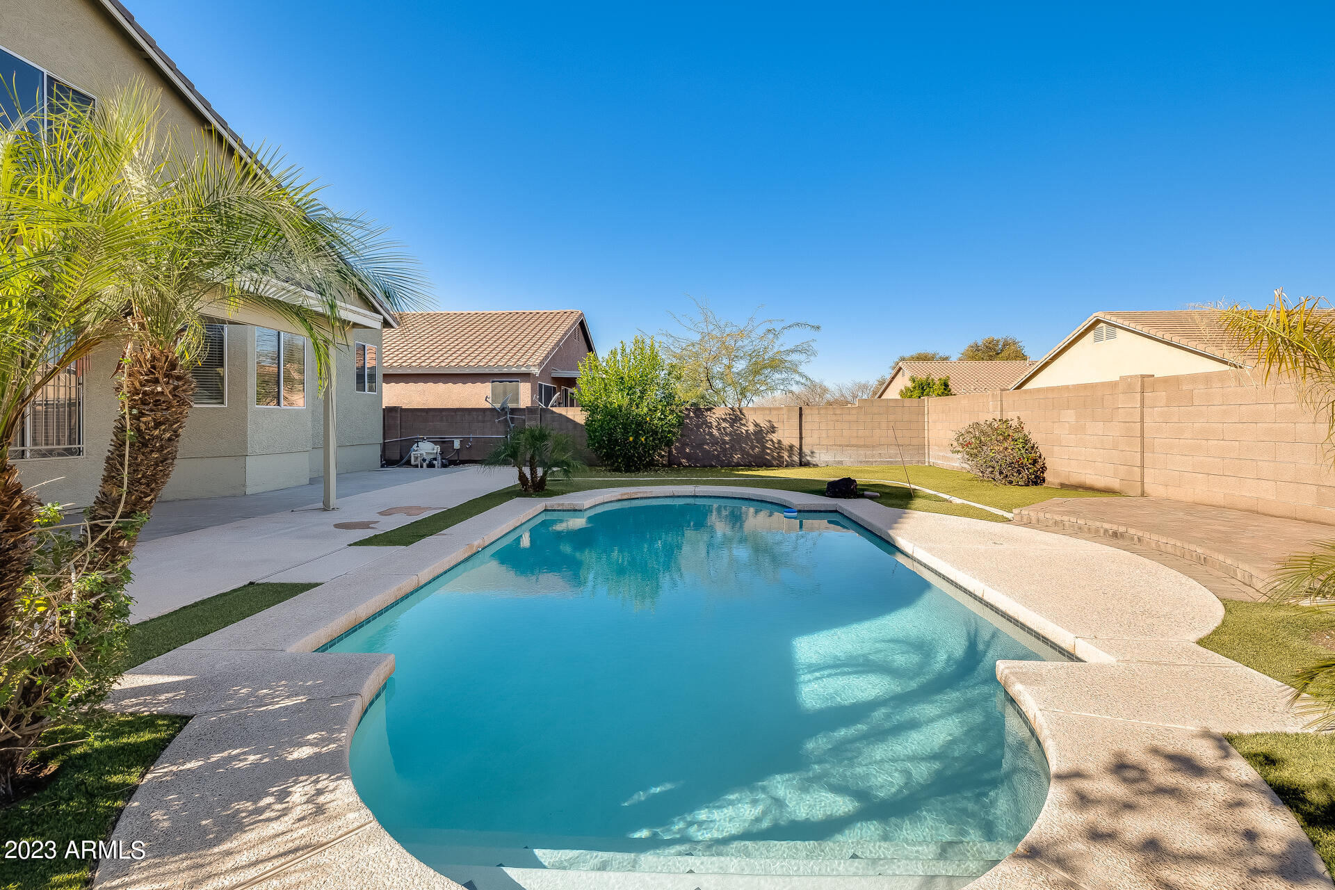 3244 West Maldonado Road Phoenix, AZ 85041 - Photo 39 of 43 a view of a swimming pool with a yard