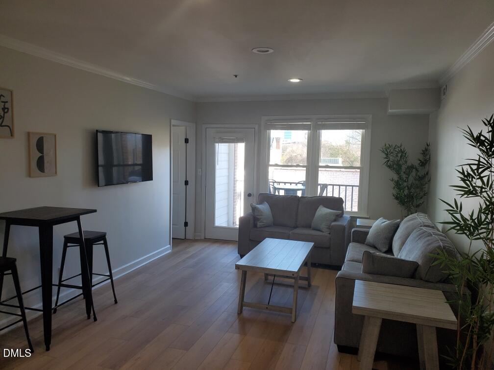 610 Hillsborough Street, Unit 205 Raleigh, NC 27603 - Photo 2 of 15 a living room with furniture and a window