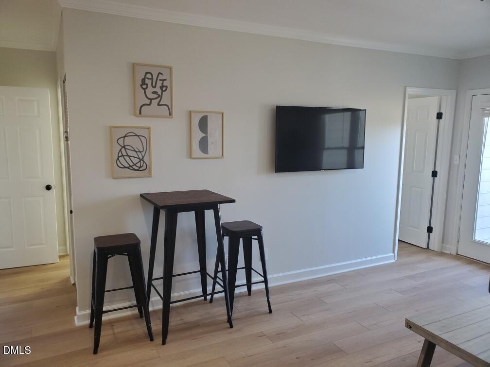 610 Hillsborough Street, Unit 205 Raleigh, NC 27603 - Photo 3 of 15 a view of a workspace with furniture and a flat screen tv