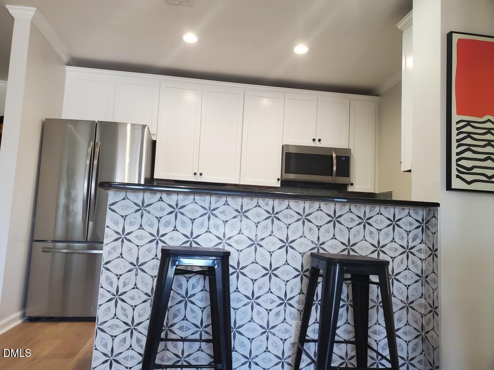 610 Hillsborough Street, Unit 205 Raleigh, NC 27603 - Photo 8 of 15 a kitchen with stainless steel appliances a refrigerator and a stove top oven