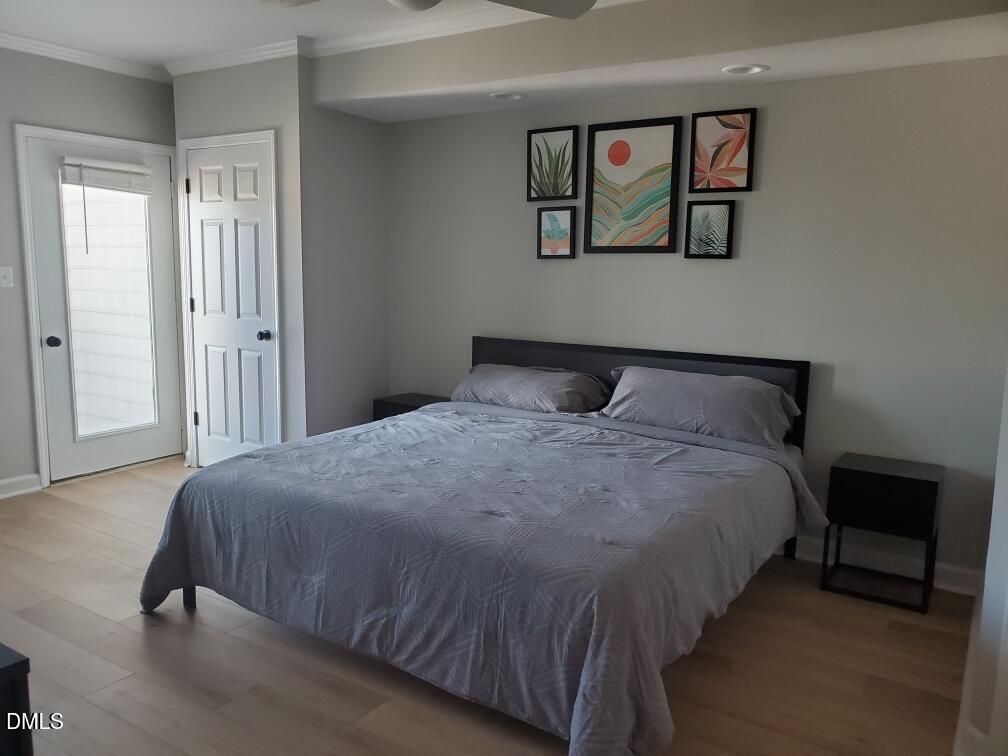 610 Hillsborough Street, Unit 205 Raleigh, NC 27603 - Photo 9 of 15 a bedroom with a bed and painting on the wall