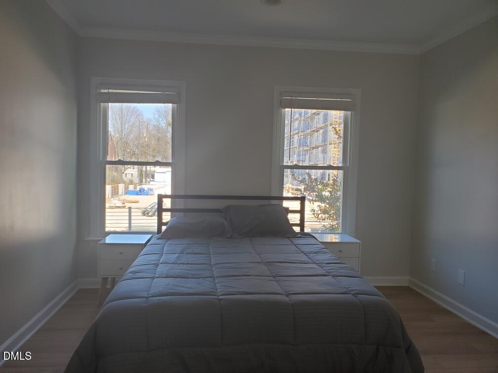 610 Hillsborough Street, Unit 205 Raleigh, NC 27603 - Photo 10 of 15 a bed sitting in a bedroom next to a window