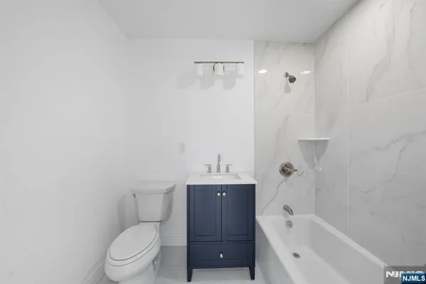 a bathroom with a bathtub toilet and sink
