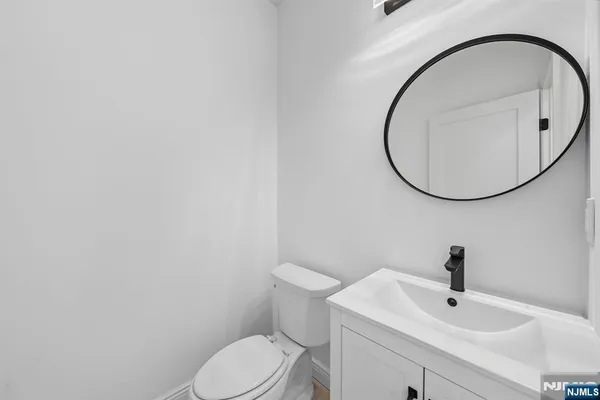 a bathroom with a sink a mirror and a toilet