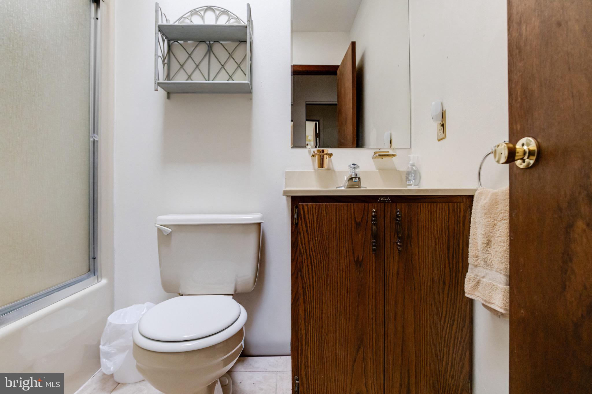 3160 Rolling Road Edgewater, MD 21037 - Photo 14 of 62 a bathroom with a sink and a toilet