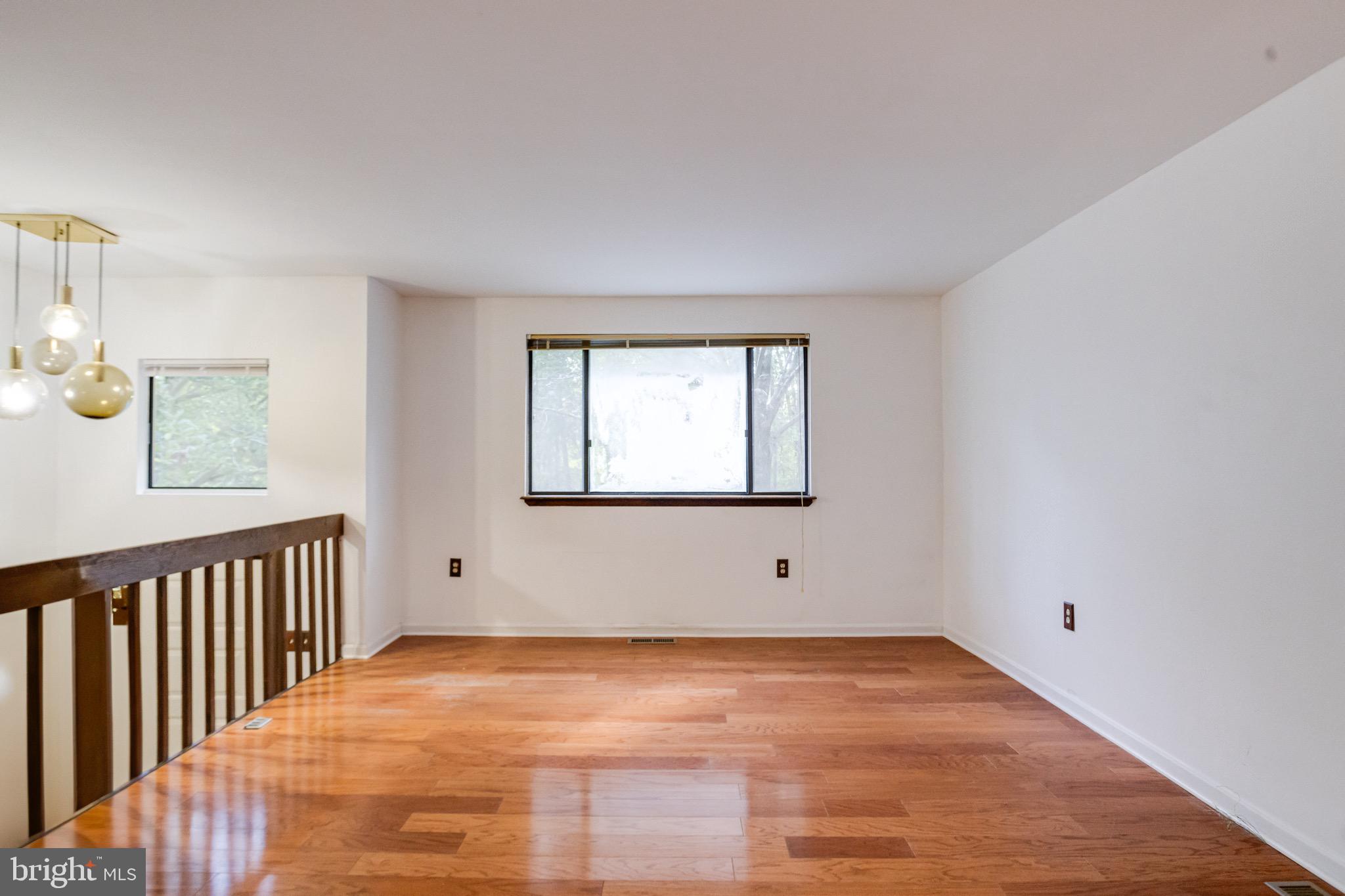 3160 Rolling Road Edgewater, MD 21037 - Photo 9 of 62 a view of an empty room with wooden floor and a window