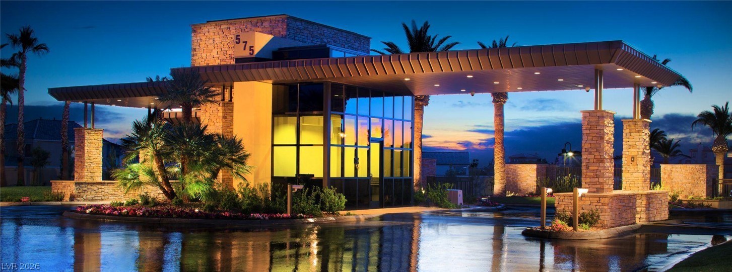 87 Tall Ruff Drive Las Vegas, NV 89148 - Photo 12 of 71 Architectural stone accents and contemporary design define this striking entrance, illuminated at twilight.