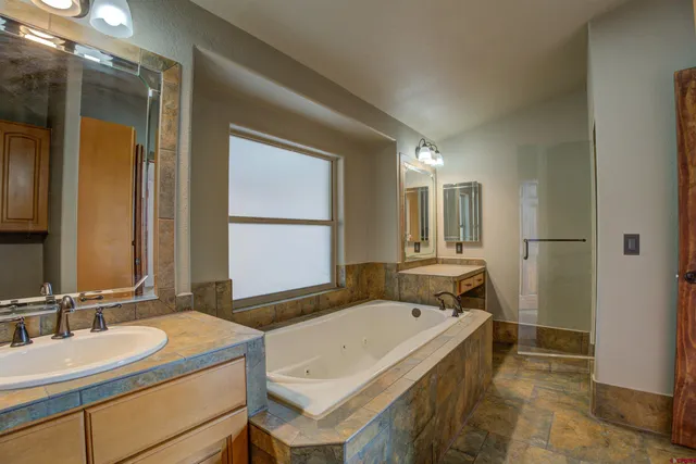a spacious bathroom with a granite countertop sink and a mirror
