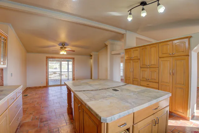 a dining hall with stainless steel appliances granite countertop a stove and refrigerator
