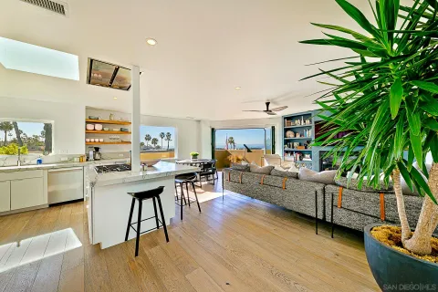 a kitchen with stainless steel appliances granite countertop a stove a sink dishwasher and a refrigerator with wooden floor