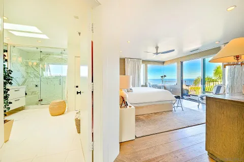 a bathroom with a sink mirror and shower