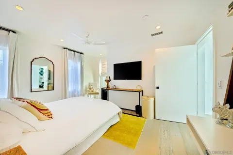a bedroom with a bed and flat screen tv