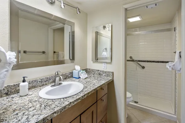 a bathroom with a sink double vanity and shower