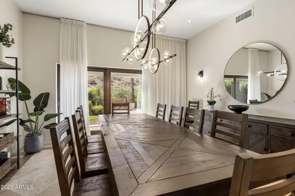 a view of a dining room with furniture and a chandelier