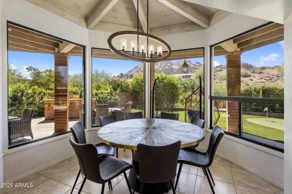 a view of a dining room with furniture large windows and wooden floor