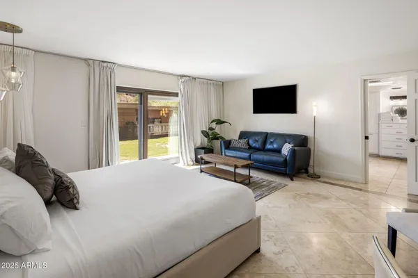 a bedroom with a bed and a couch