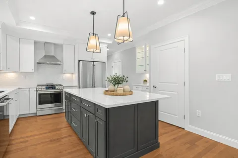 a kitchen with stainless steel appliances granite countertop a sink and a refrigerator