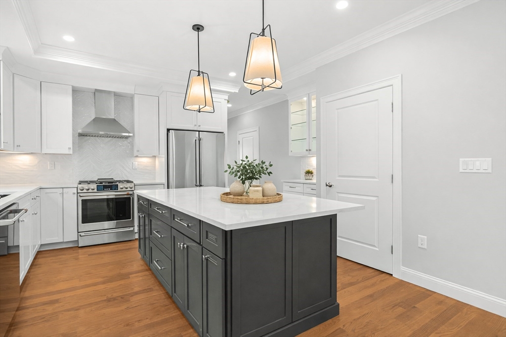 26 Flagg Street Woburn, MA 01801 - Photo 12 of 39 a kitchen with stainless steel appliances granite countertop a sink and a refrigerator