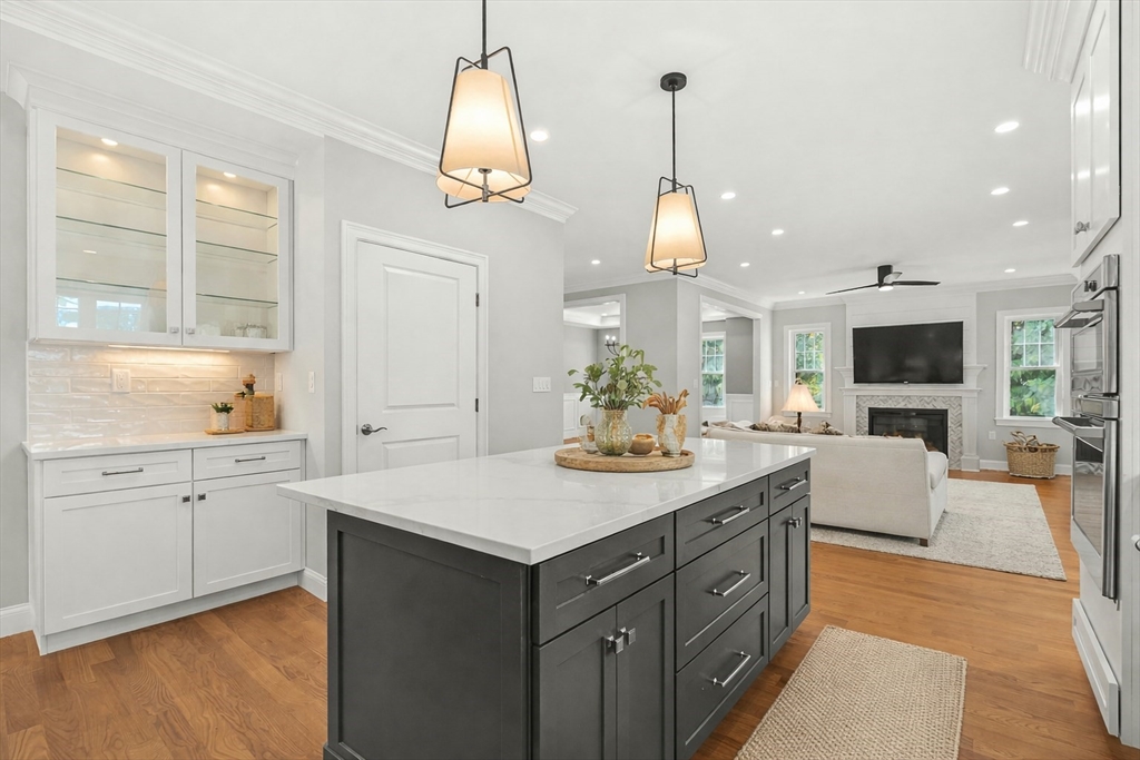 26 Flagg Street Woburn, MA 01801 - Photo 13 of 39 a kitchen with a sink stove and wooden floor