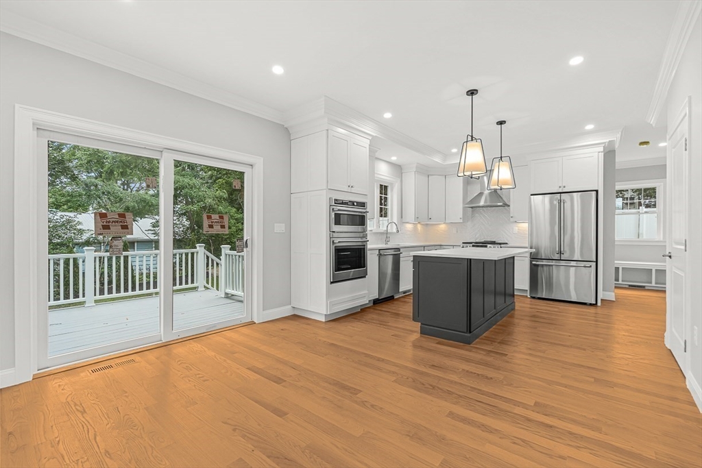 26 Flagg Street Woburn, MA 01801 - Photo 14 of 39 a view of kitchen with stainless steel appliances wooden floor and large window