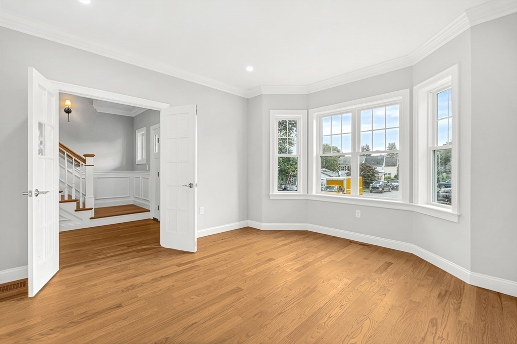 26 Flagg Street Woburn, MA 01801 - Photo 20 of 39 an empty room with wooden floor and windows