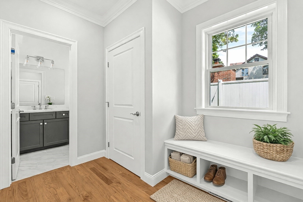 26 Flagg Street Woburn, MA 01801 - Photo 22 of 39 a kitchen with stainless steel appliances kitchen island a stove a sink and a window