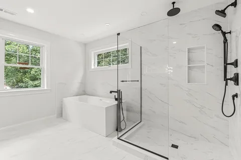 a bathroom with a shower bathtub and window
