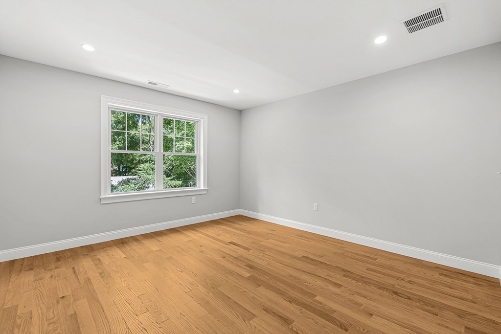 26 Flagg Street Woburn, MA 01801 - Photo 33 of 39 an empty room with wooden floor and windows