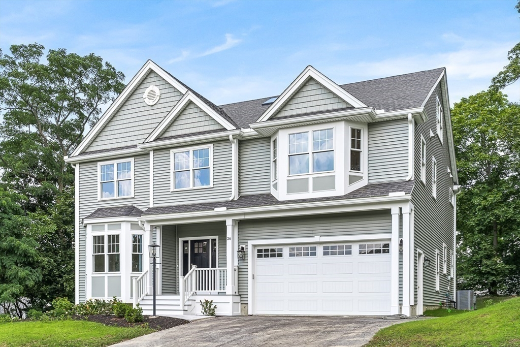 26 Flagg Street Woburn, MA 01801 - Photo 6 of 39 a front view of a house with a yard and garage