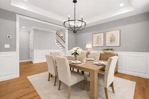 a view of a dining room with furniture wooden floor and a chandelier