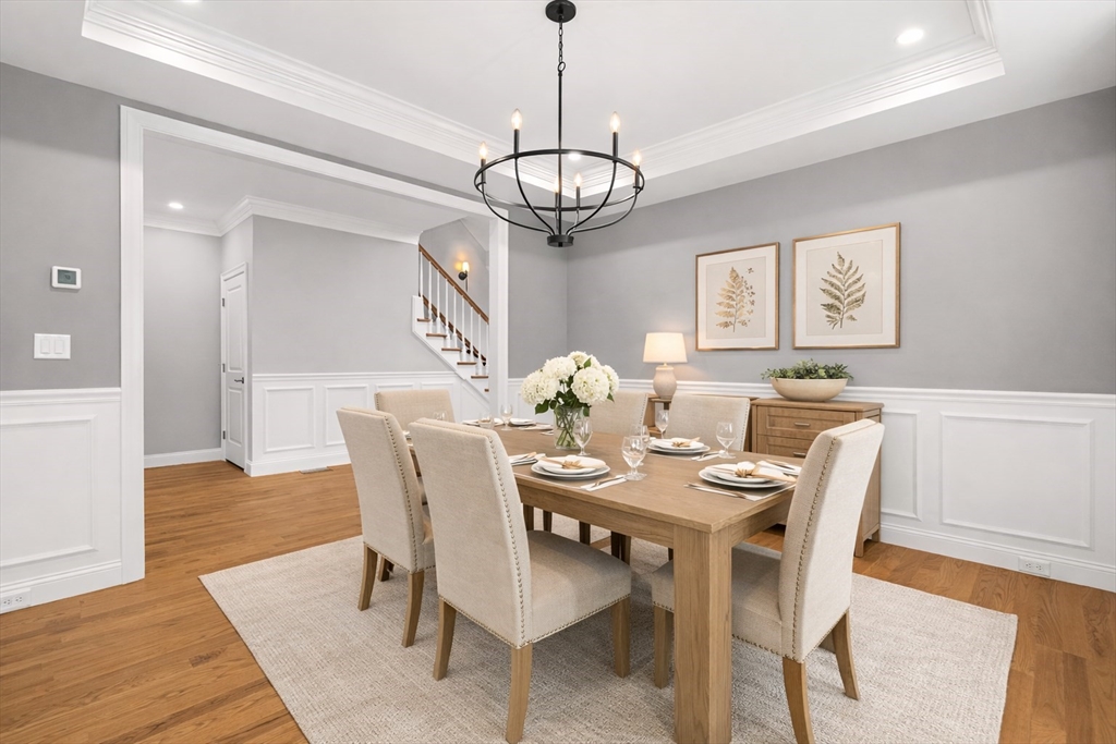 26 Flagg Street Woburn, MA 01801 - Photo 9 of 39 a view of a dining room with furniture wooden floor and a chandelier