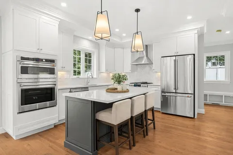 a kitchen with stainless steel appliances granite countertop a refrigerator a stove a sink and a refrigerator