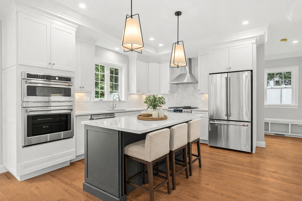 26 Flagg Street Woburn, MA 01801 - Photo 10 of 39 a kitchen with stainless steel appliances granite countertop a refrigerator a stove a sink and a refrigerator