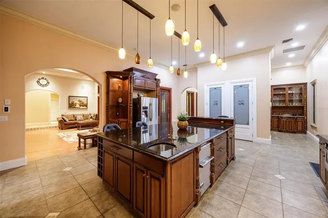 a view of a house with a big yard and potted plants