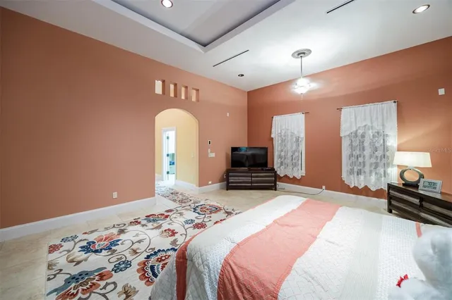 a view of a house with potted plants and a table and chairs