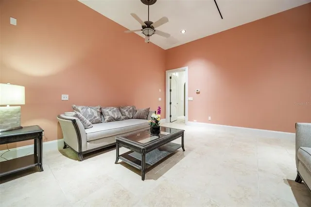 a view of a livingroom with furniture and a floor to ceiling window
