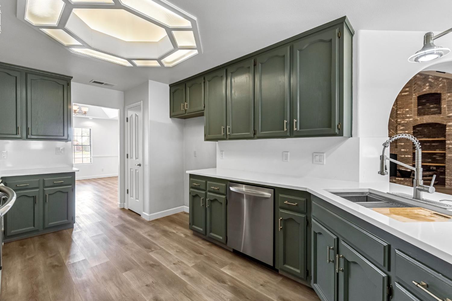 36065 Manon Avenue Madera, CA 93636 - Photo 11 of 50 a kitchen with stainless steel appliances granite countertop a sink stove and cabinets