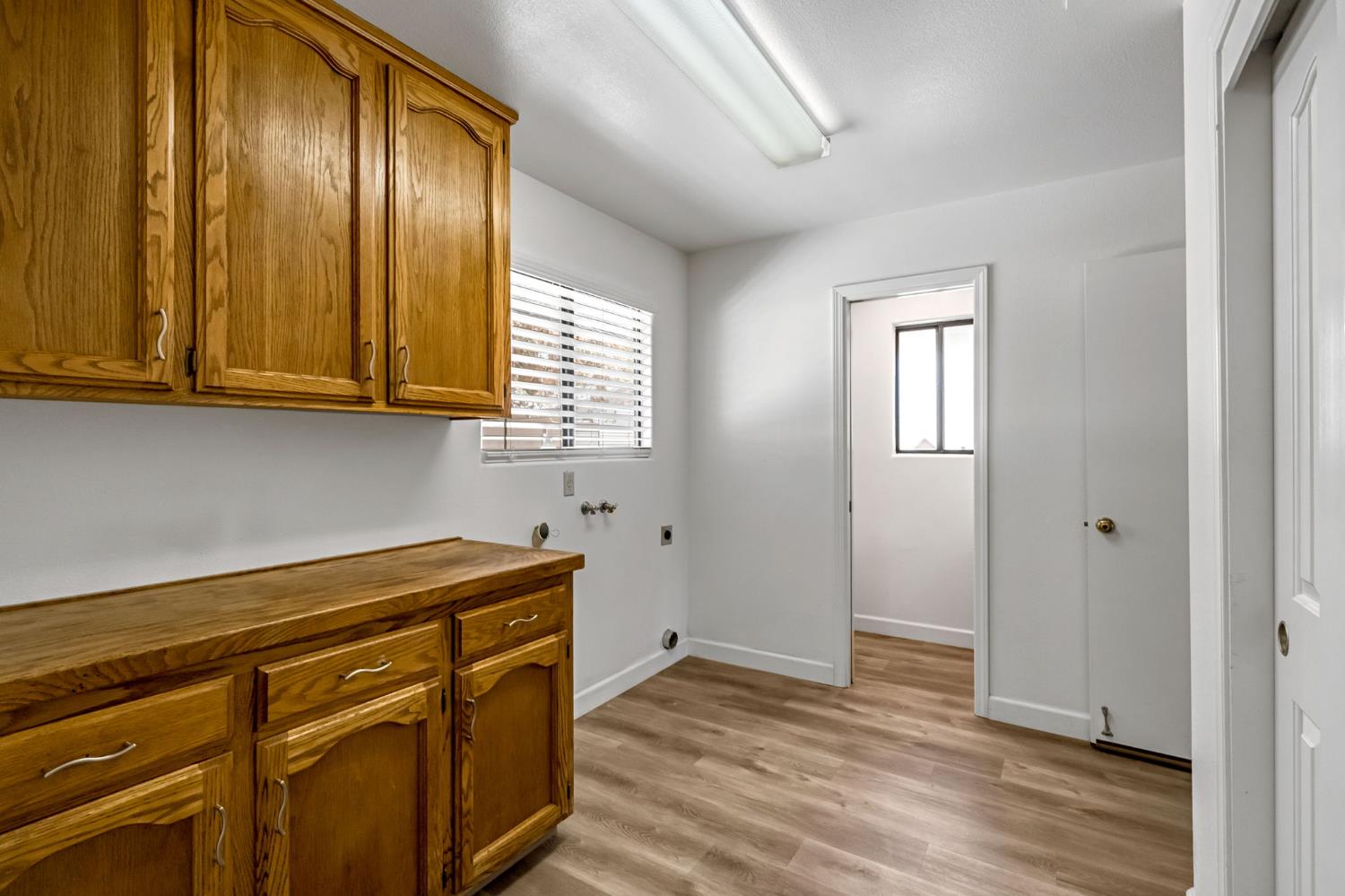 36065 Manon Avenue Madera, CA 93636 - Photo 17 of 50 a view of a kitchen with wooden floor and cabinets