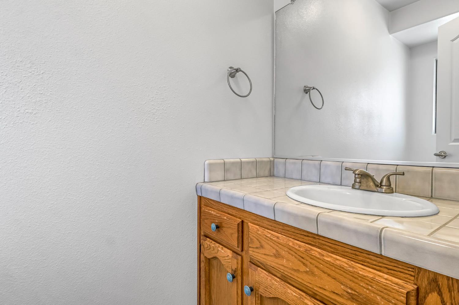 36065 Manon Avenue Madera, CA 93636 - Photo 22 of 50 a bathroom with a granite countertop sink and a mirror