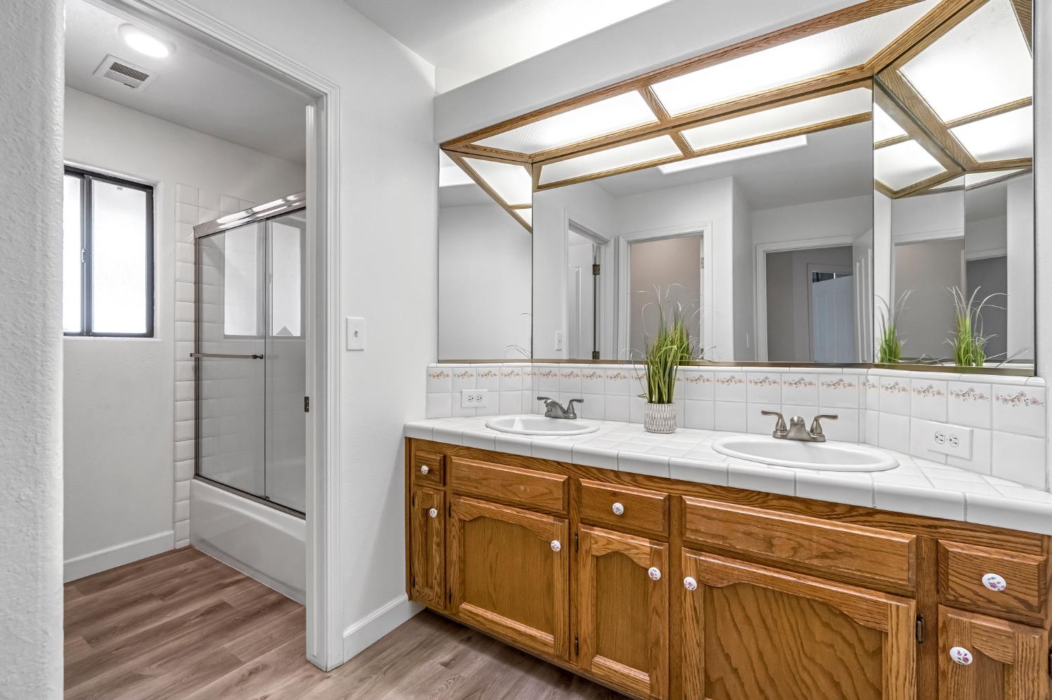 36065 Manon Avenue Madera, CA 93636 - Photo 27 of 50 a bathroom with a double vanity sink and mirror
