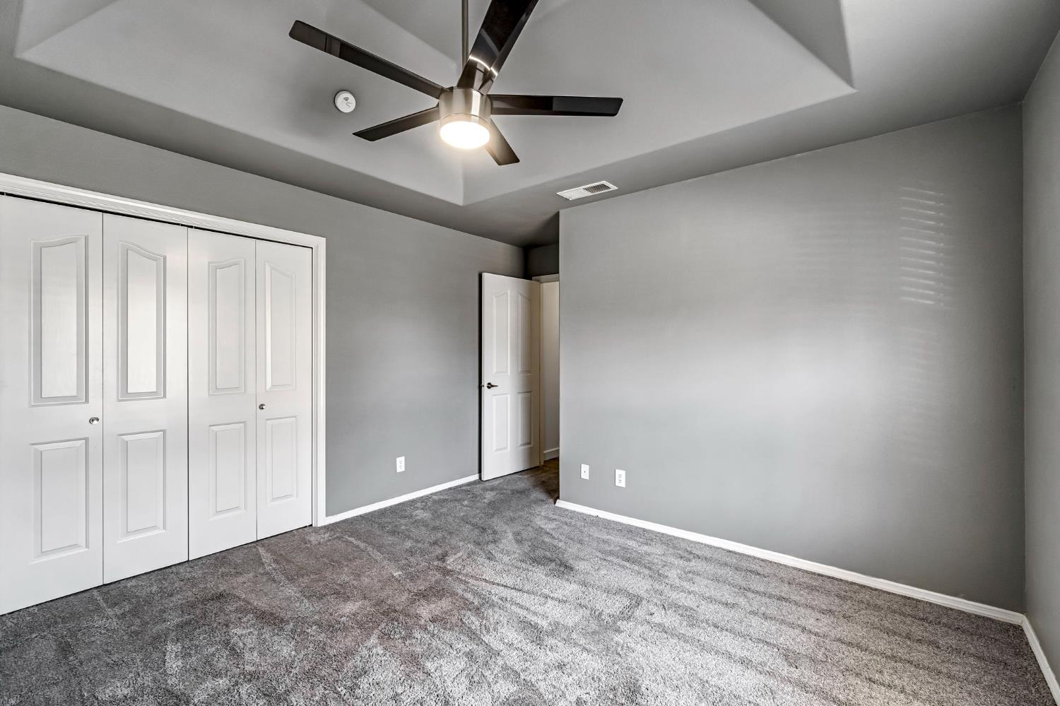 36065 Manon Avenue Madera, CA 93636 - Photo 29 of 50 an empty room with ceiling fan and window