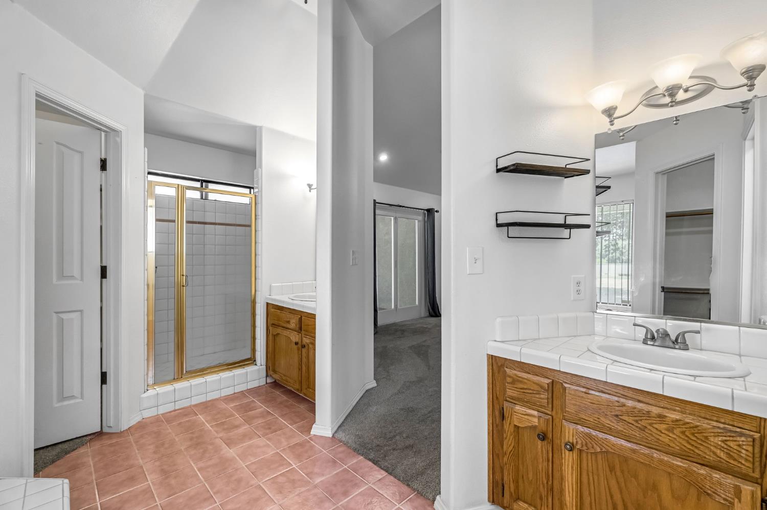 36065 Manon Avenue Madera, CA 93636 - Photo 32 of 50 a spacious bathroom with a granite countertop sink mirror and shower